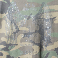 Close-up of Angel Wings Hoodie – rhinestone wings and text artwork on camo fleece