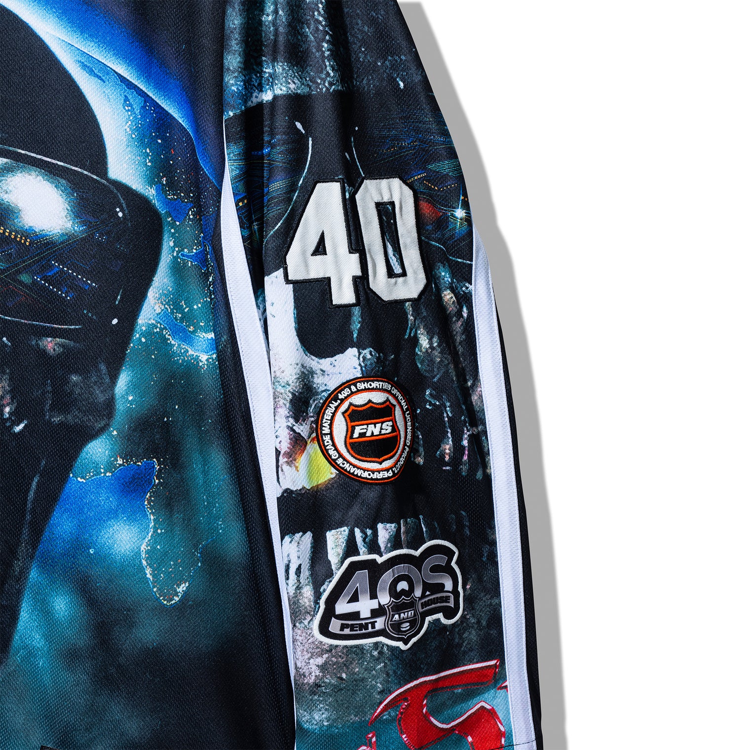 Left sleeve detail of the Tales Hockey Jersey with layered skull artwork, number 40, and multiple patches.