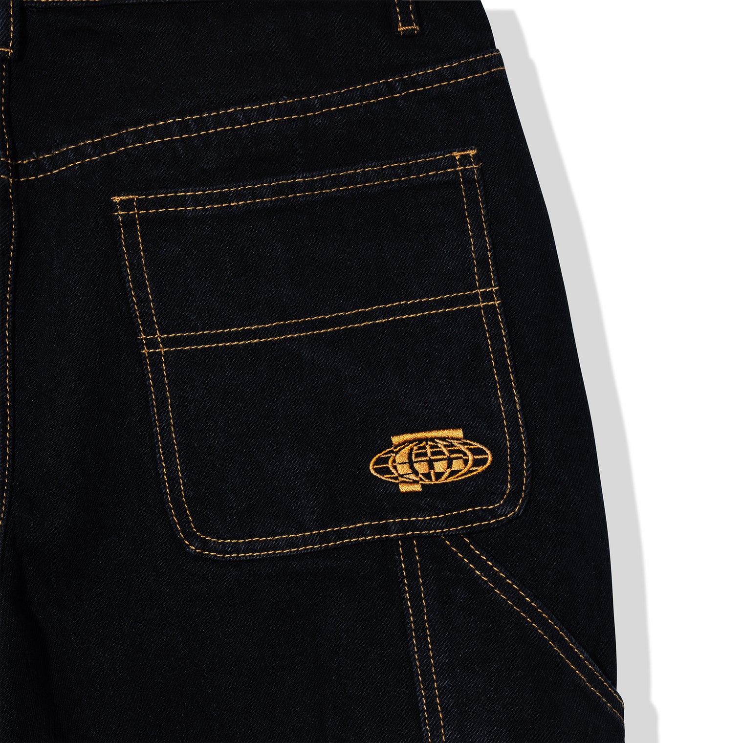 Close-up of back pocket embroidery on Standard Carpenter Shorts featuring gold stitched globe logo