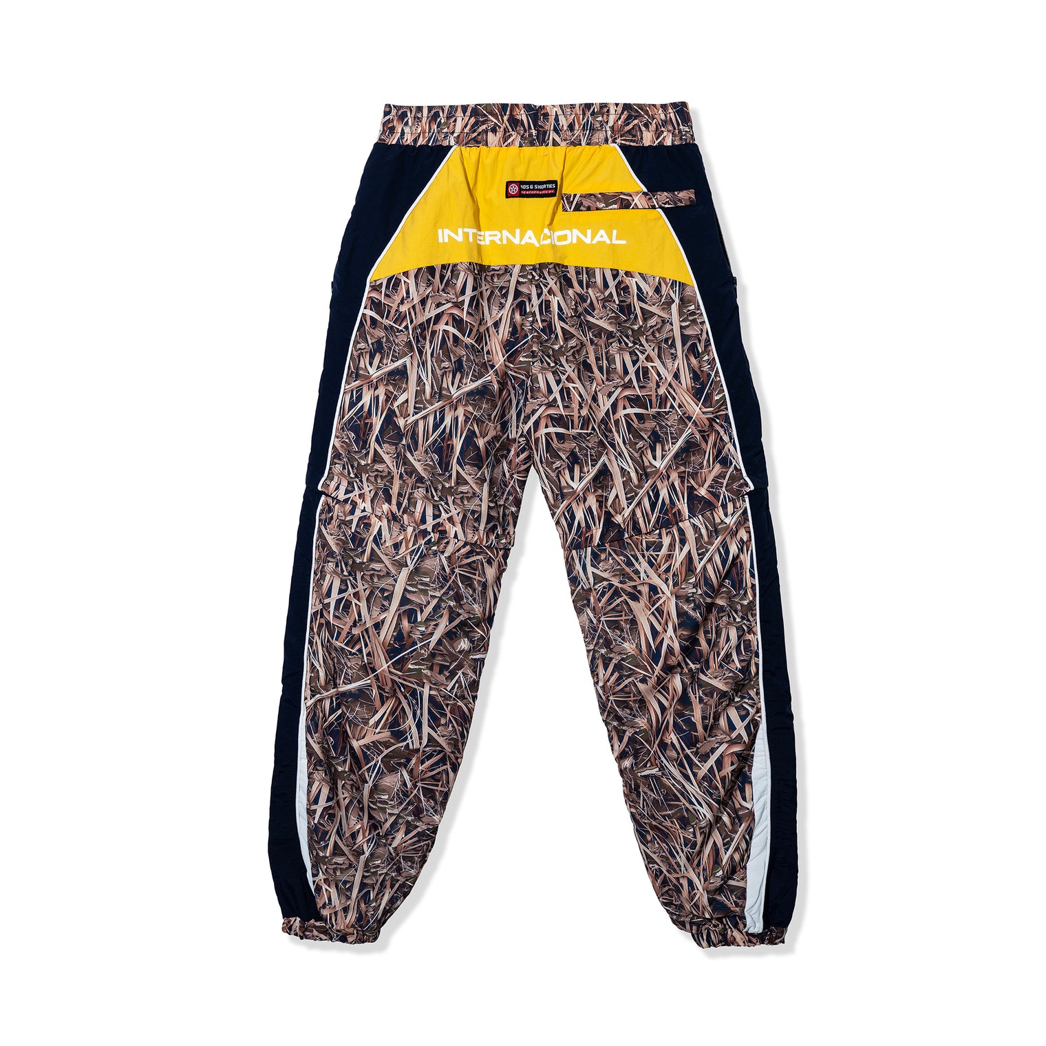 Full back view of Reed Camo Track Pants with yellow contrast panel and "Internacional" print