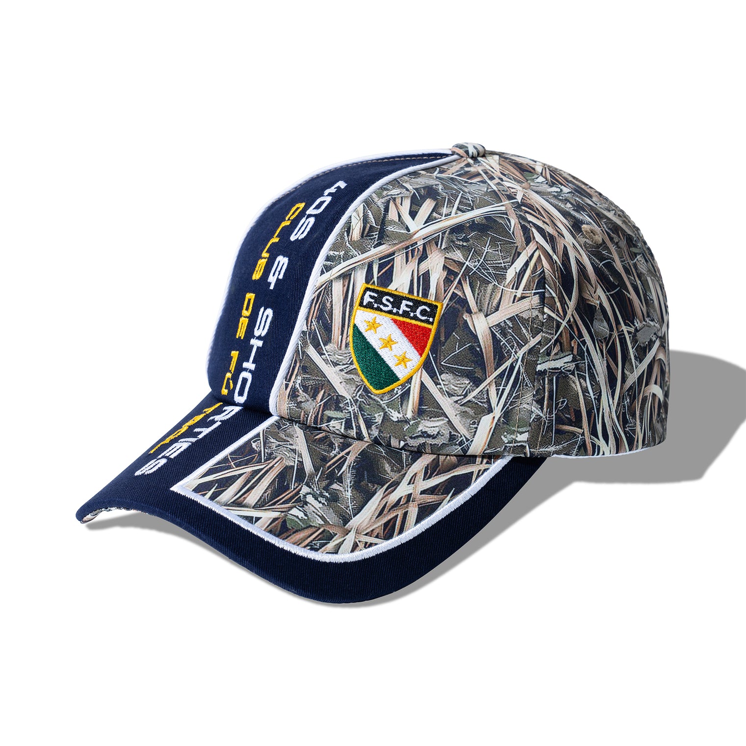 Angled side view of the Reed Camo Cap highlighting camo paneling and embroidered badge