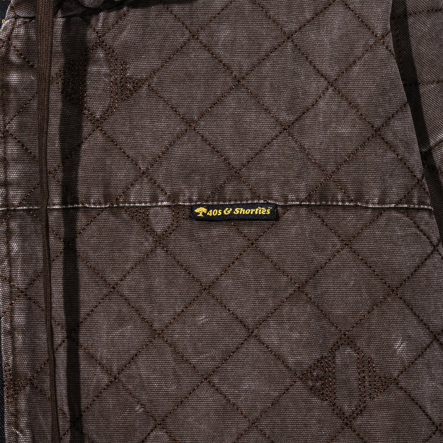 Close-up of 40s & Shorties woven label on the Foreman Hooded Jacket