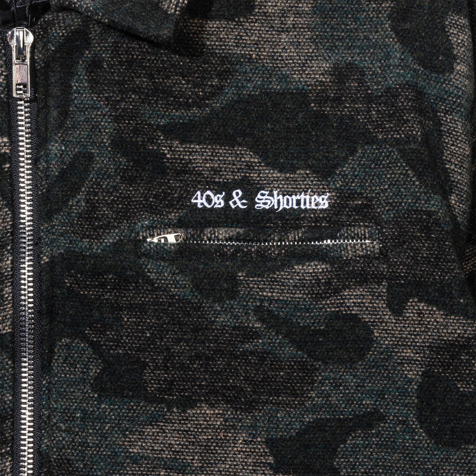 Close-up of chest embroidery and zip pocket on Wool Camo Jacket