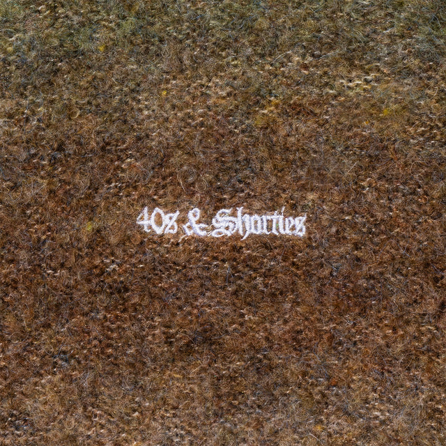 Close-up of chest embroidery detail on the Teen Spirit Sweater – Green