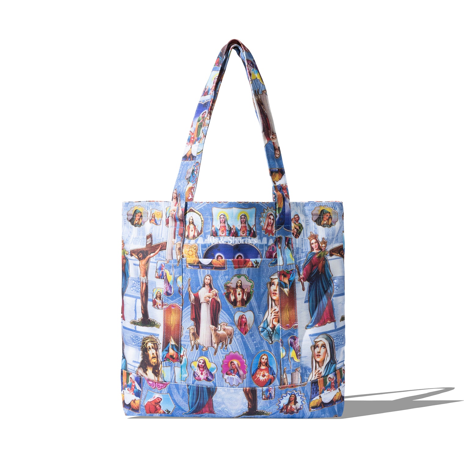 Holy Spirit Tote Bag in blue with full sublimated print of religious iconography and 40s & Shorties branding on the front pocket.