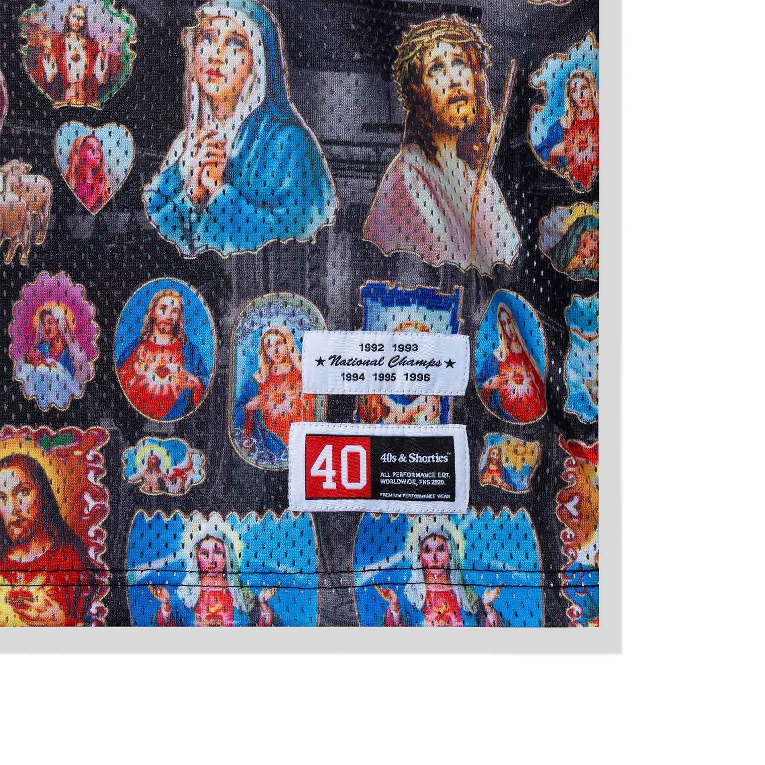 Zoomed-in view of woven patch tags at bottom hem reading "National Champs" and 40s branding