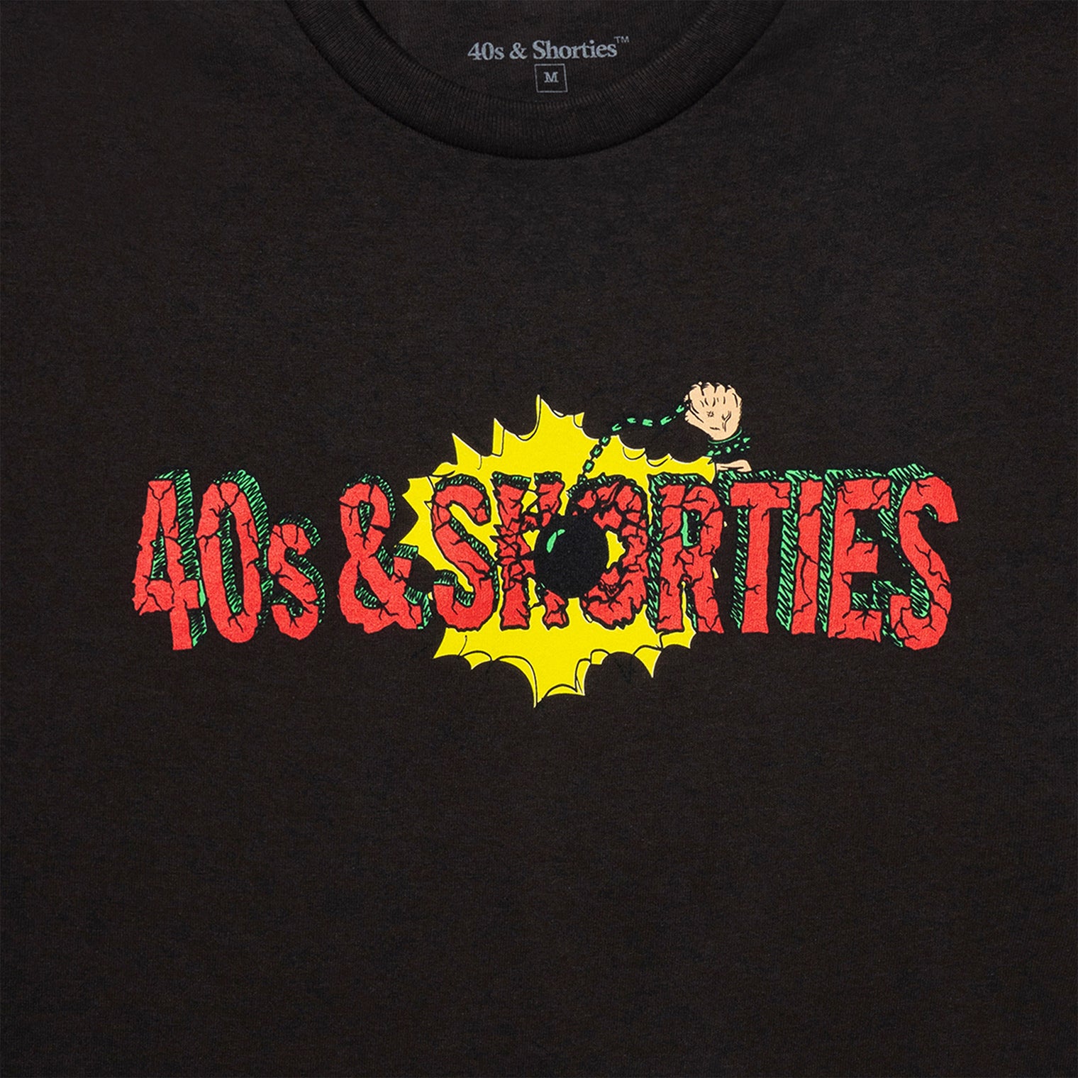Detail of Smashing Tee in Dark Chocolate with 40s & Shorties logo and wrecking ball illustration.