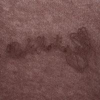 Close-up of embroidered “40s & Shorties” logo and hearts across the chest.