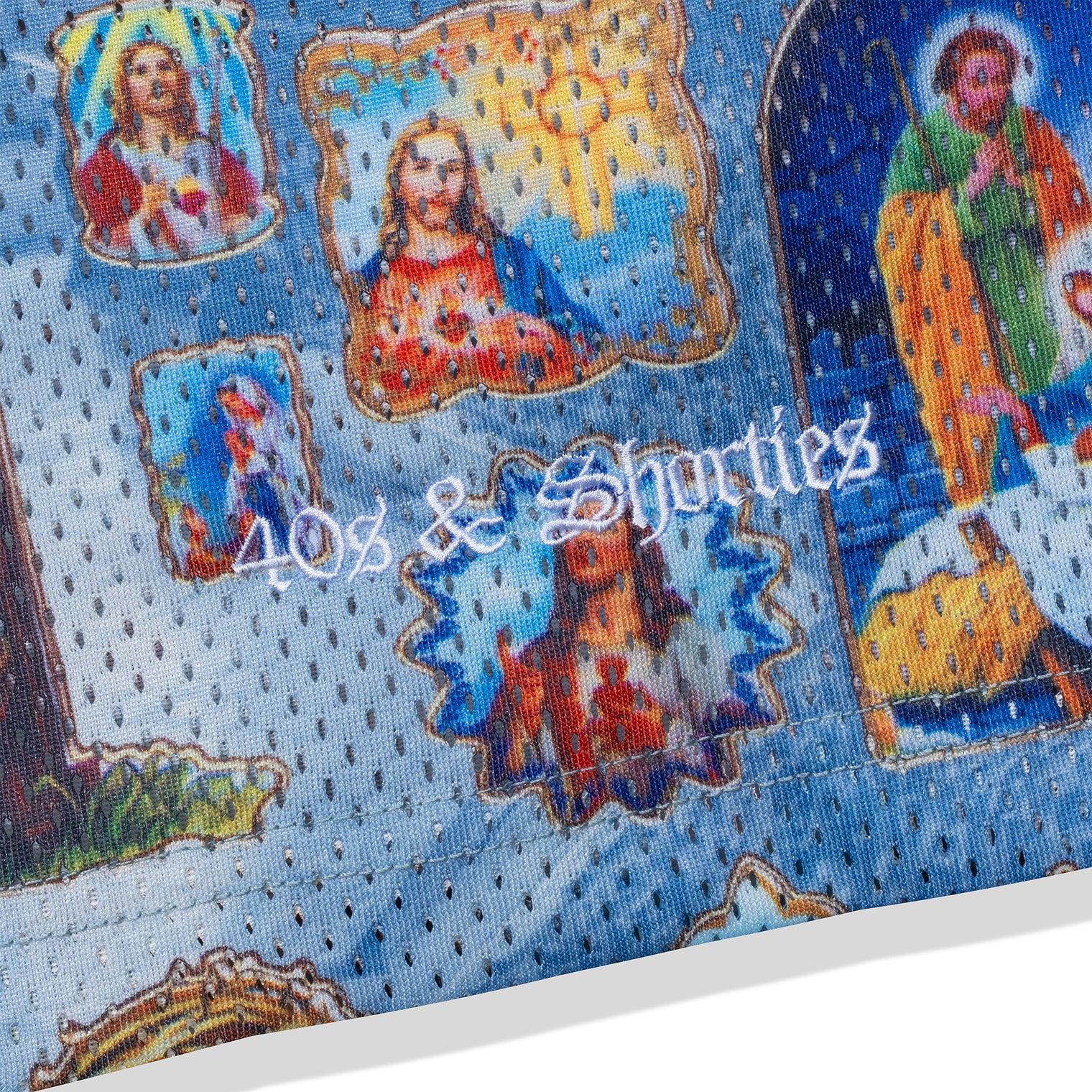 Close-up of embroidered “40s & Shorties” logo on mesh fabric with religious print