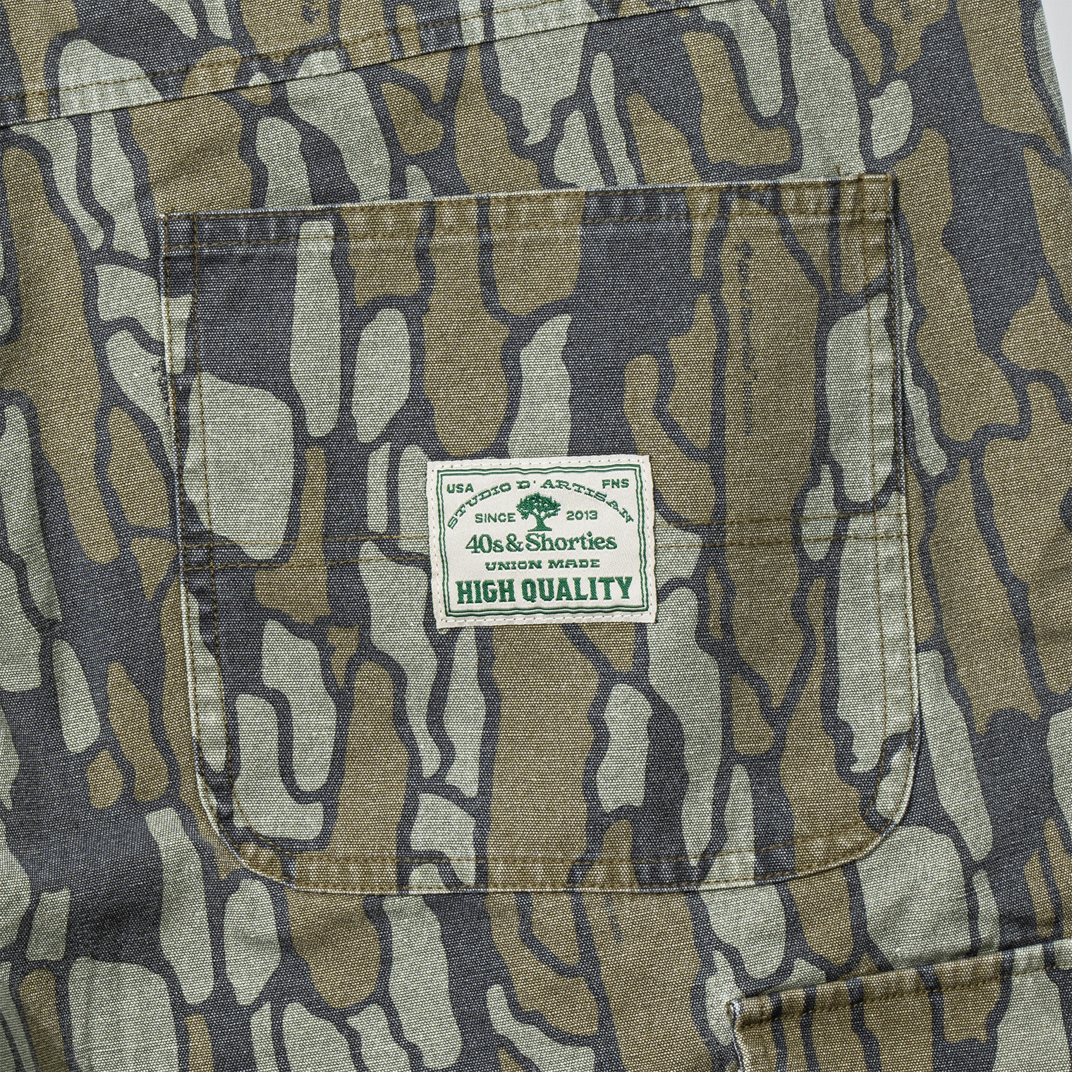 Close-up of back pocket with green 40s & Shorties woven label reading "High Quality"