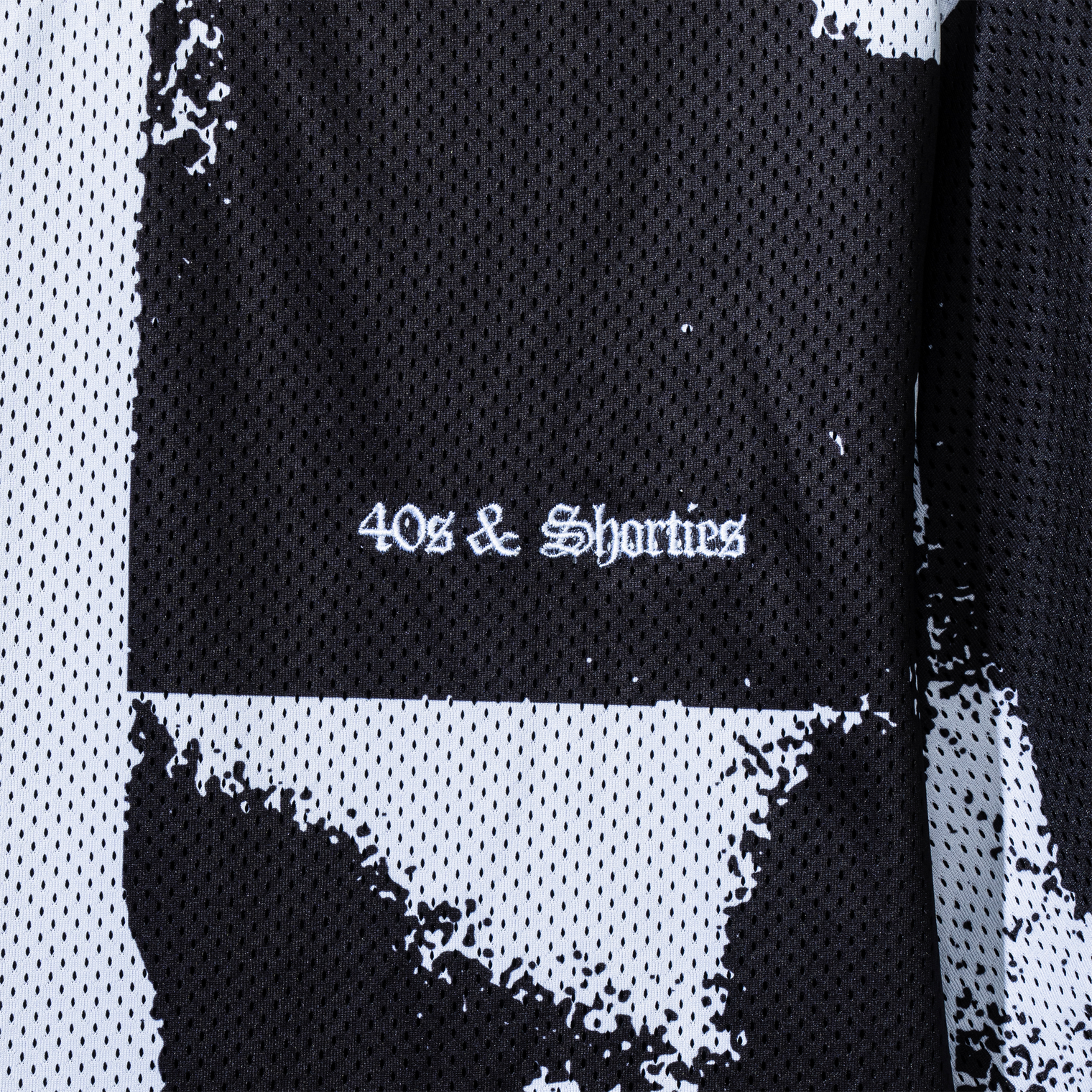 Close-up of embroidered 40s & Shorties logo on the lips graphic side