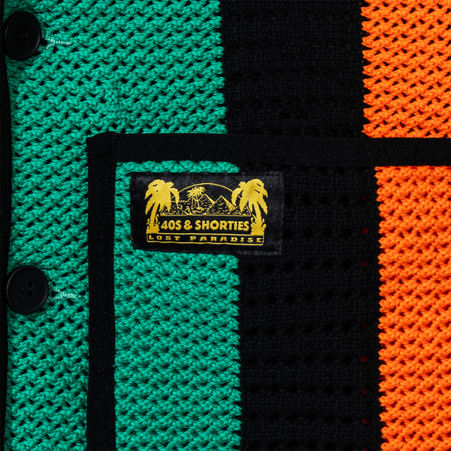 Close-up of pocket label – Yellow and black woven "40s & Shorties Lost Paradise" label stitched above the right pocket.