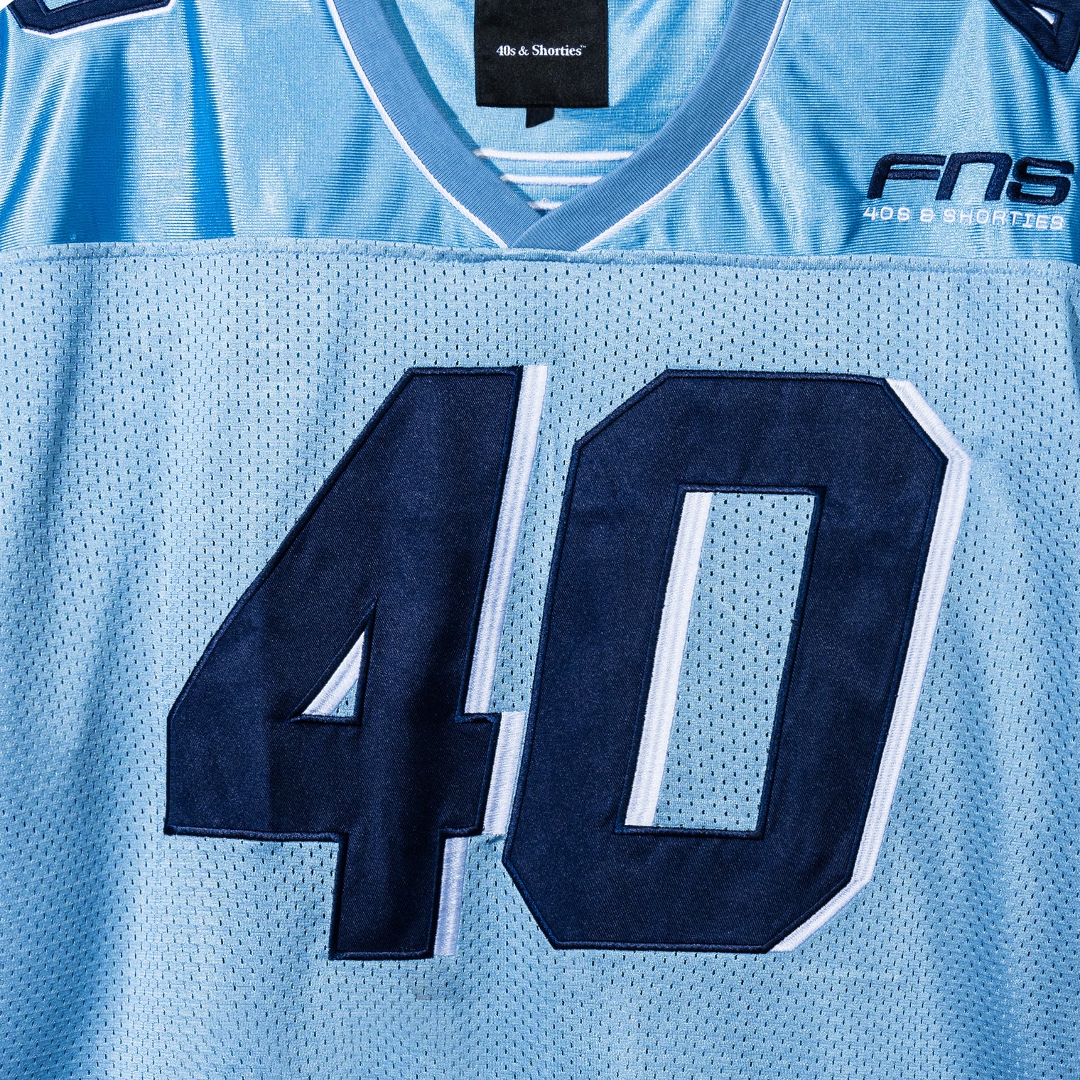 Close-up of front “40” appliqué and FNS chest embroidery on the lue Fubar Jersey by 40s & Shorties.