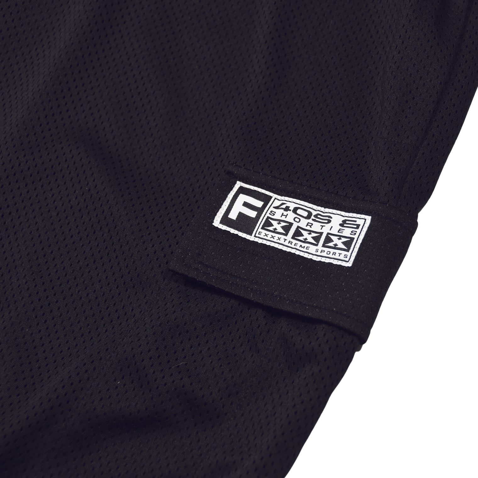 Close-up of the 40s & Shorties woven logo patch on the side cargo pocket.
