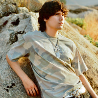 Model wearing 40s & Shorties Angel Wings Tee in camo with rhinestone script logo on chest.