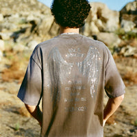 Back of 40s & Shorties Angel Wings Tee black featuring rhinestone angel wings and tribute text.