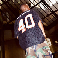 Lifestyle photo: back view of model wearing the Crochet Football Jersey
