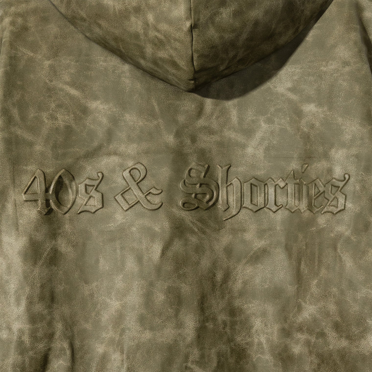 Macro close-up of molded 40s & Shorties back logo on Damien Zip Hoodie – Brown