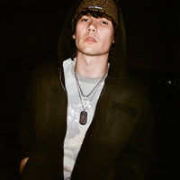 Model wearing 40s & Shorties Faded Logo Zip Hoodie black shot at night.