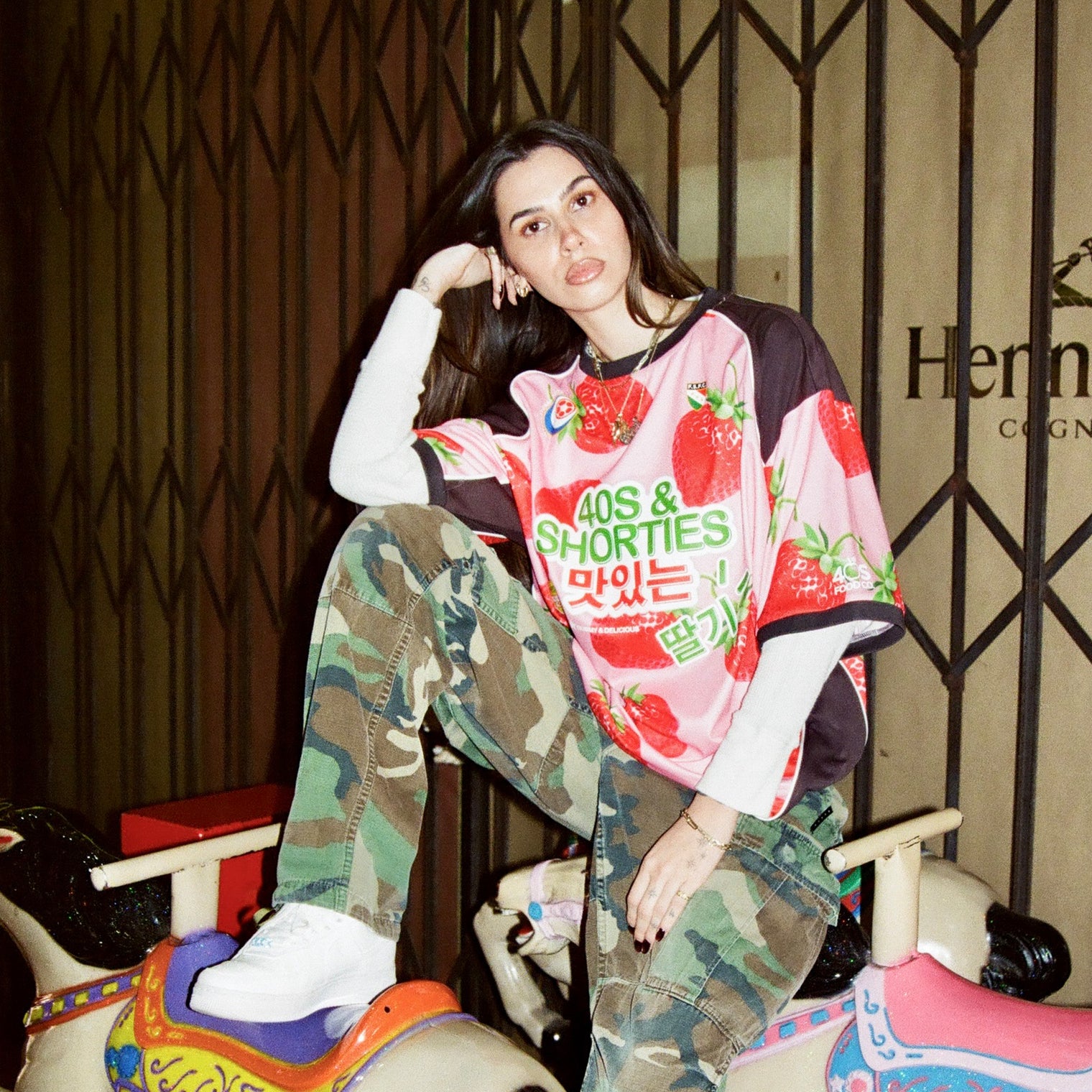 Model sitting on a ride-on horse wearing the jersey styled with long sleeves