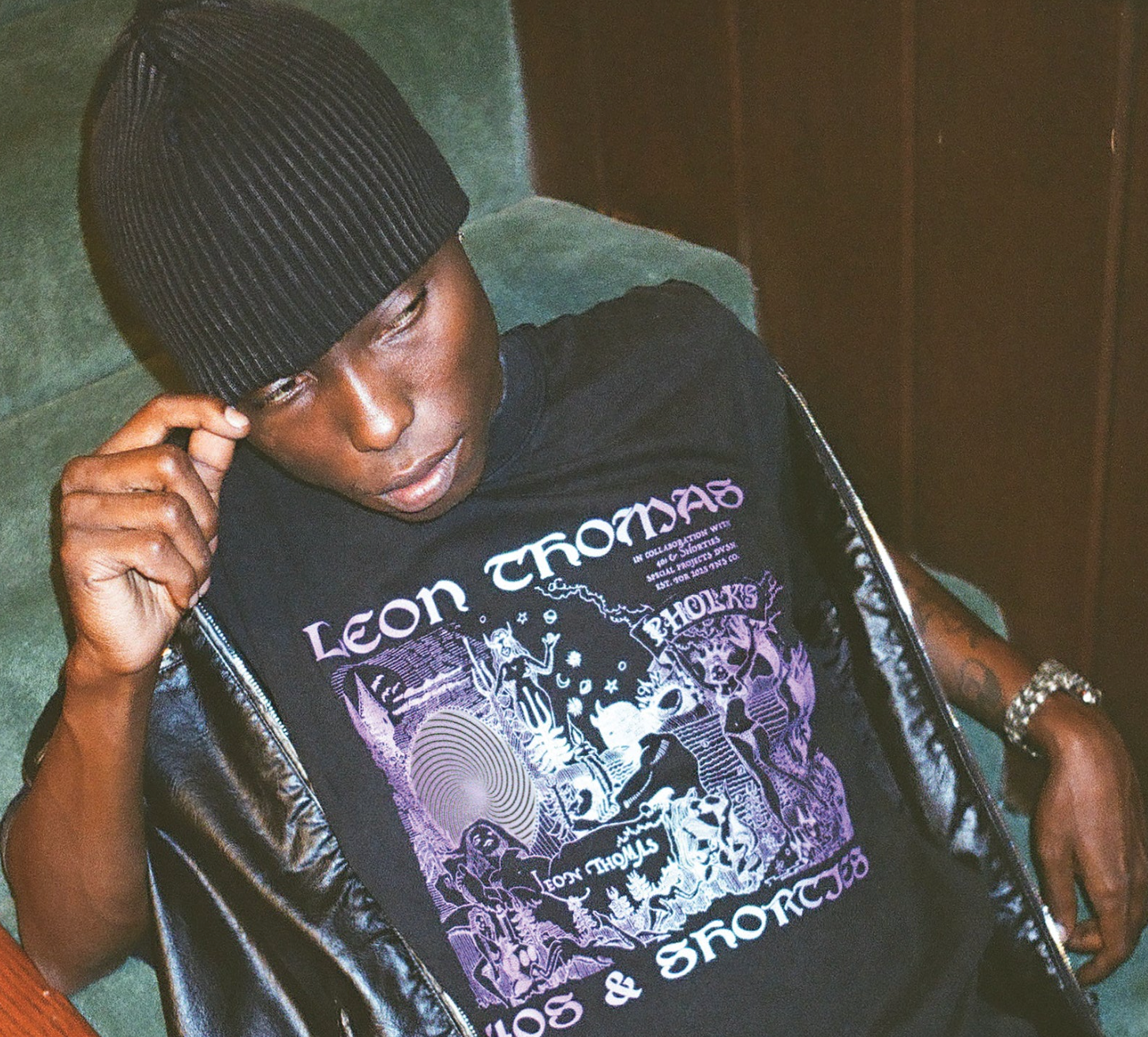 Model wearing Trippy Tee in black with surreal Pholks-inspired front artwork