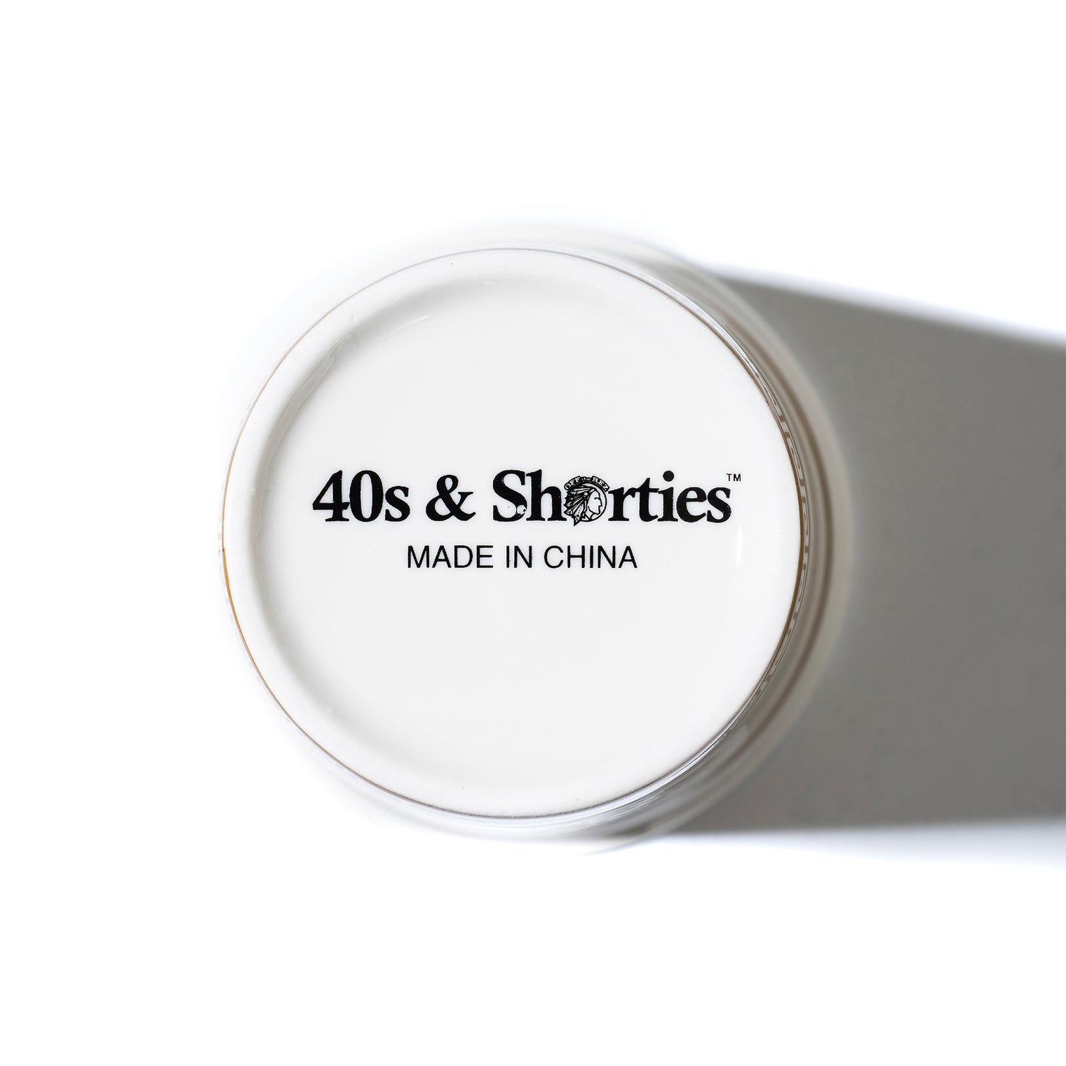 Bottom of the Ceramic Coffee Cup with black 40s & Shorties logo and “Made in China” text printed on the white ceramic base.