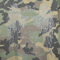 Close-up of Angel Wings Hoodie – rhinestone wings and text artwork on camo fleece