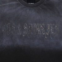 Close-up of rhinestone 40s & Shorties logo on chest of Angel Wings Tee in Charcoal
