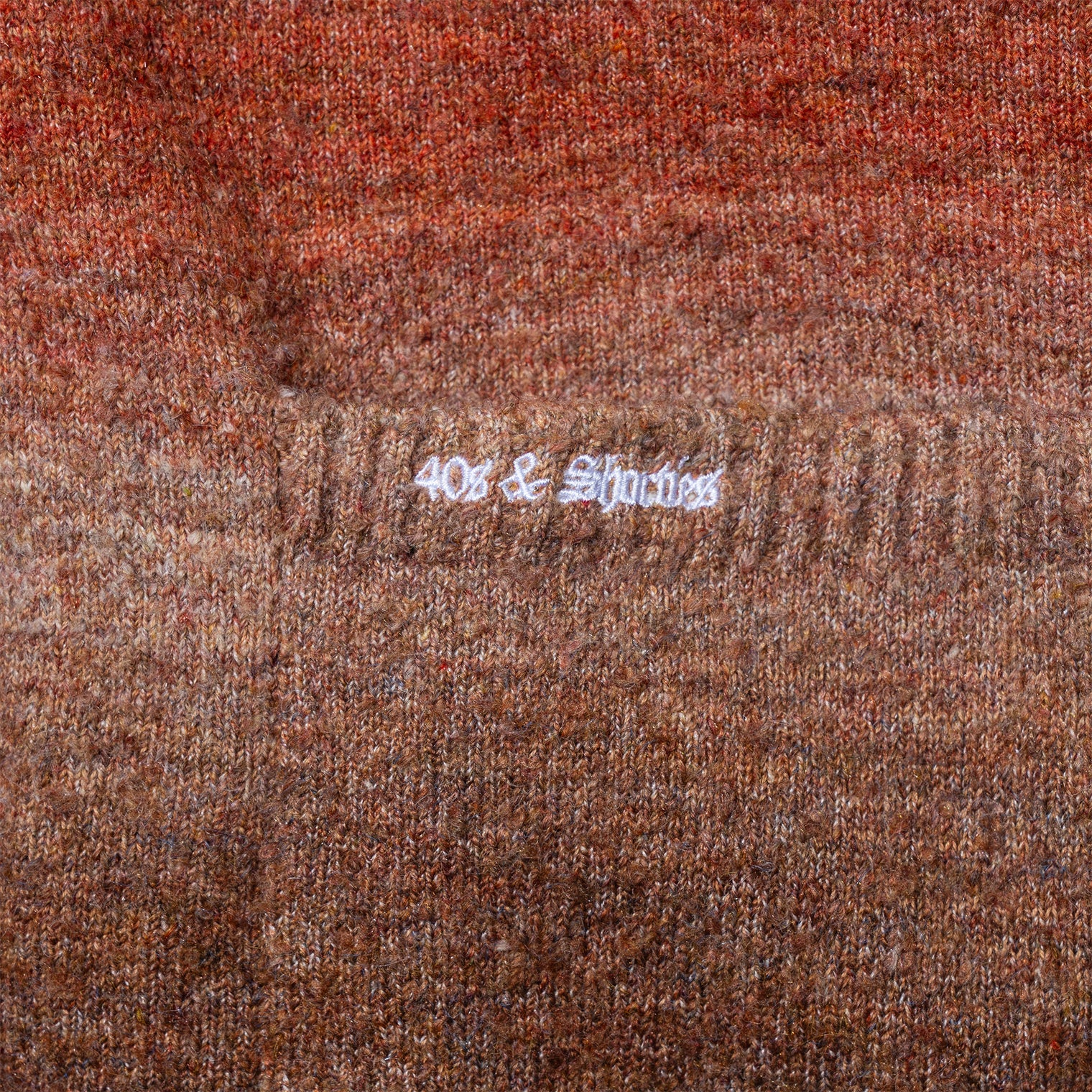 Close-up of 40s & Shorties embroidery on front pocket of the Lithium Cardigan
