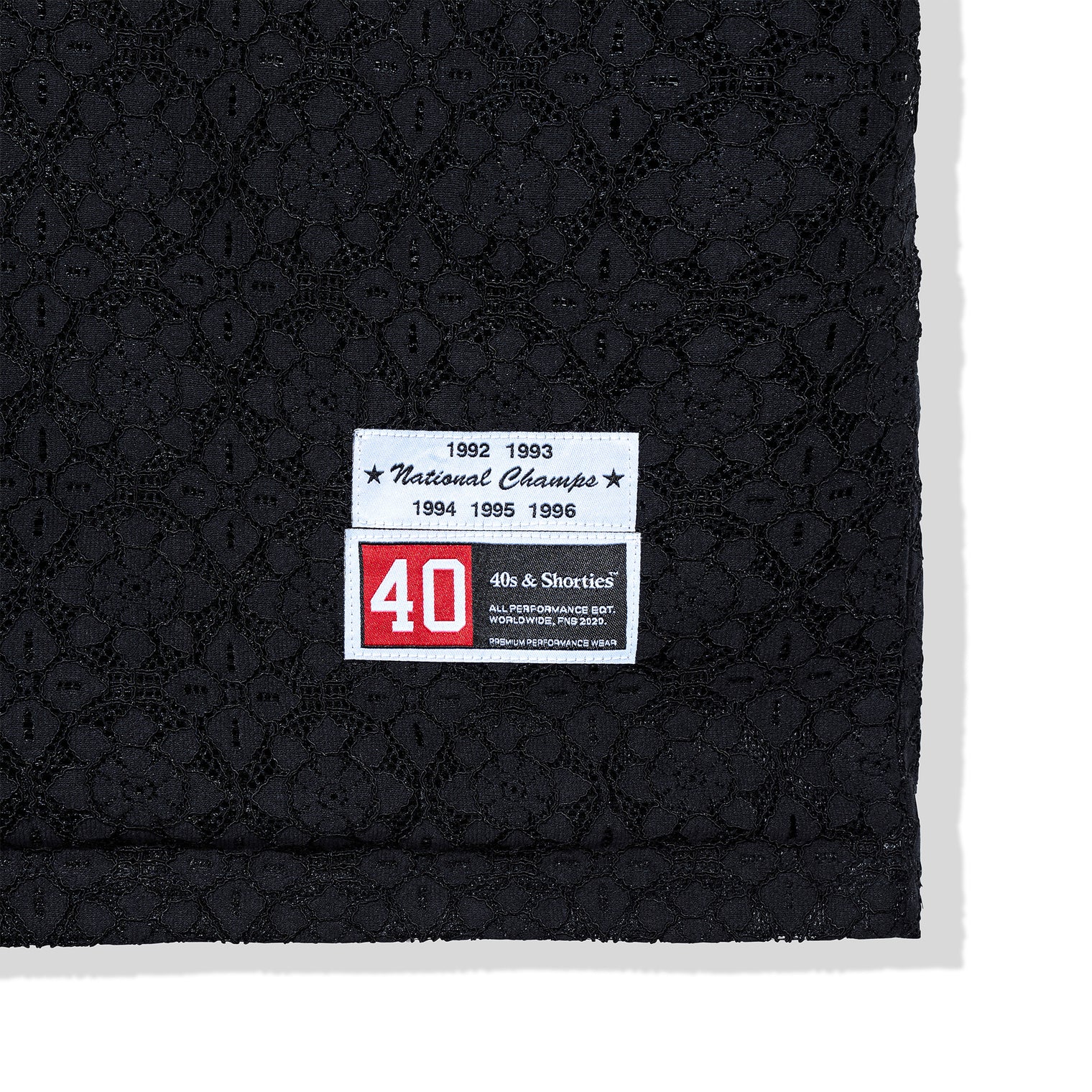 Woven label detail near hem of the Crochet Football Jersey
