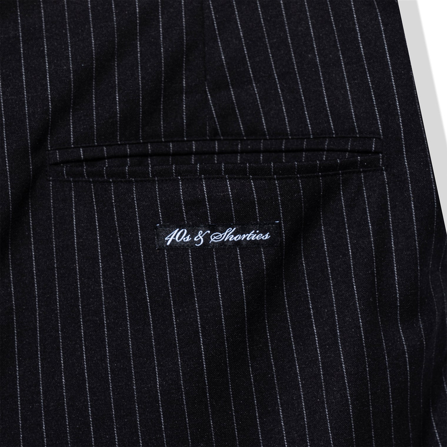 Close-up of pinstripe fabric and 40s & Shorties label detailing on the back pocket