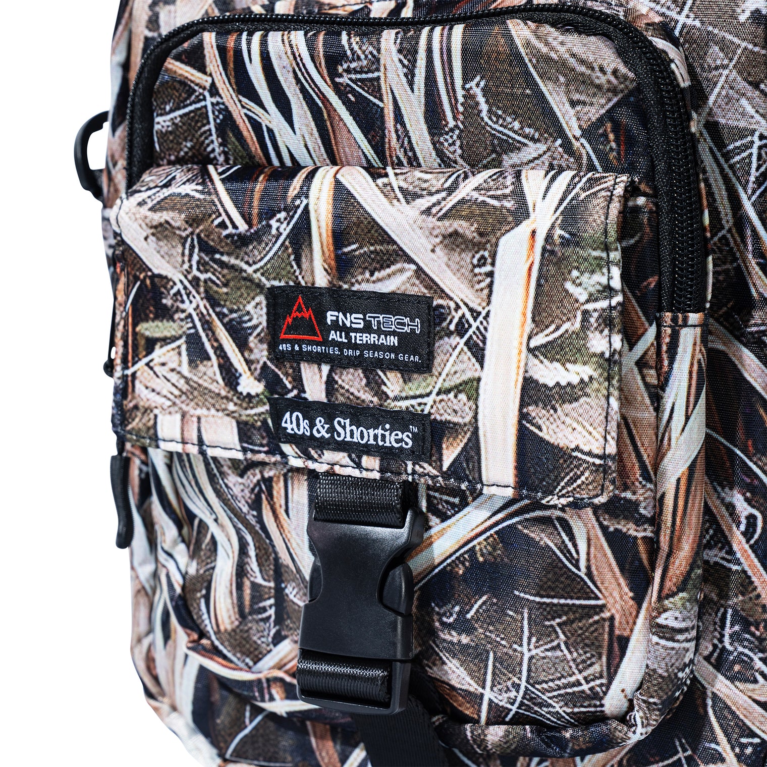 Close-up of the front pocket showing FNS Tech and 40s & Shorties logo patches
