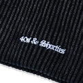 Close-up of white embroidered 40s & Shorties logo on ribbed acrylic knit of OG Text Beanie – Multi

