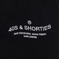 Close-up of 40s & Shorties “Bad Decisions, Good Times, Worldwide” printed logo on sweatpants
