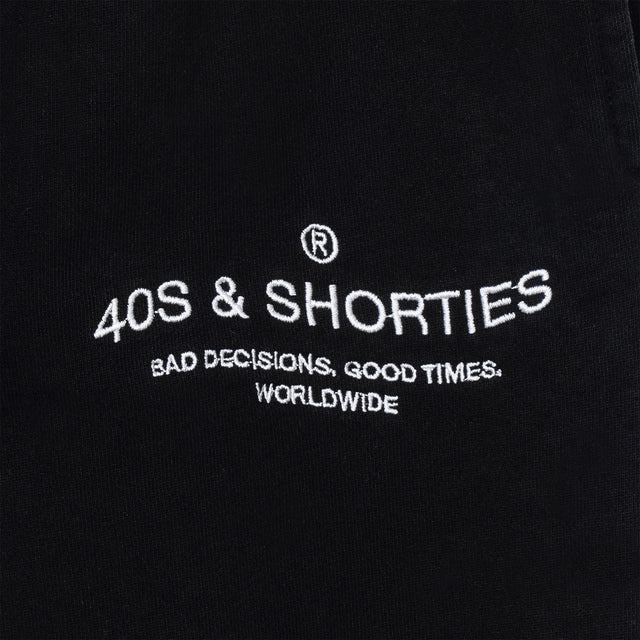 Close-up of 40s & Shorties “Bad Decisions, Good Times, Worldwide” printed logo on sweatpants
