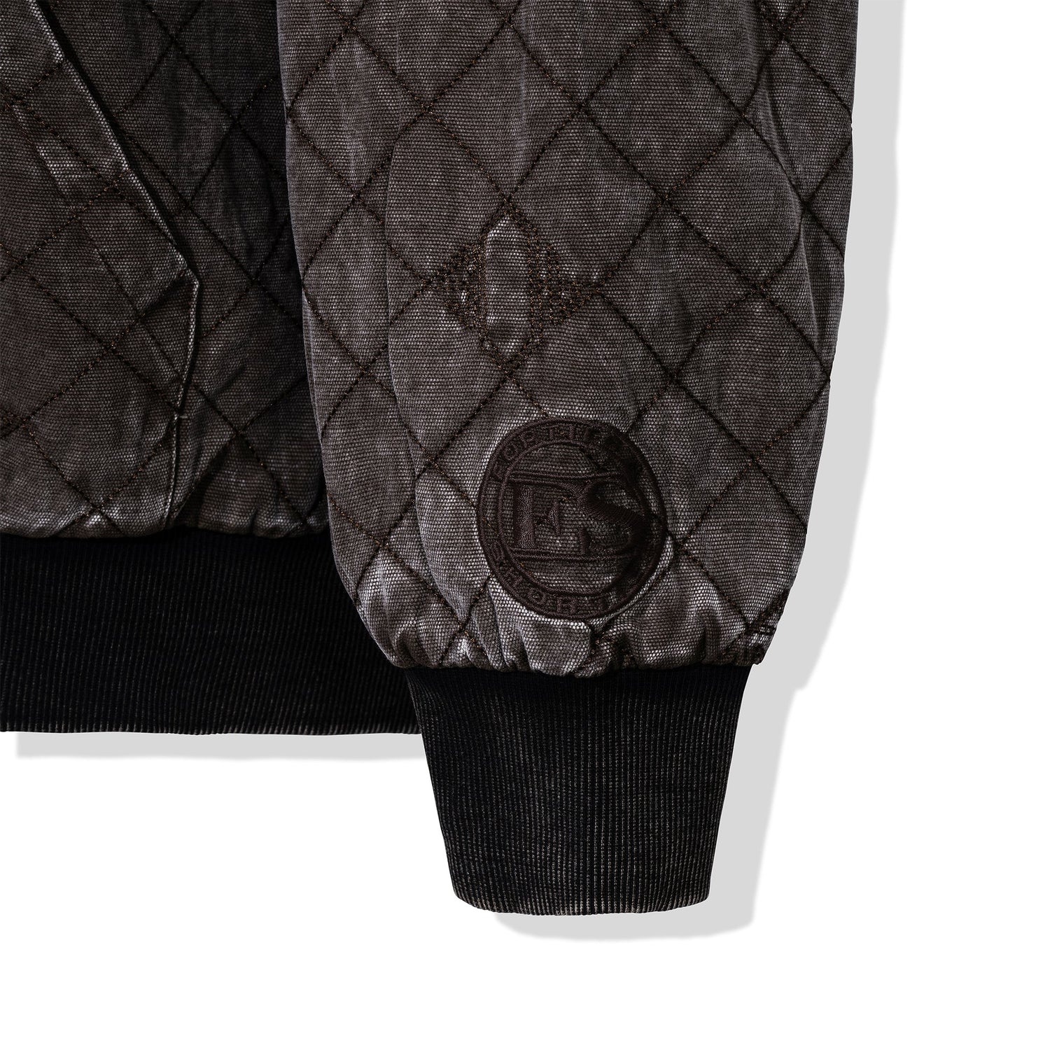 Detail of quilted embroidery and 40s & Shorties crest patch on the sleeve
