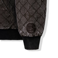 Detail of quilted embroidery and 40s & Shorties crest patch on the sleeve
