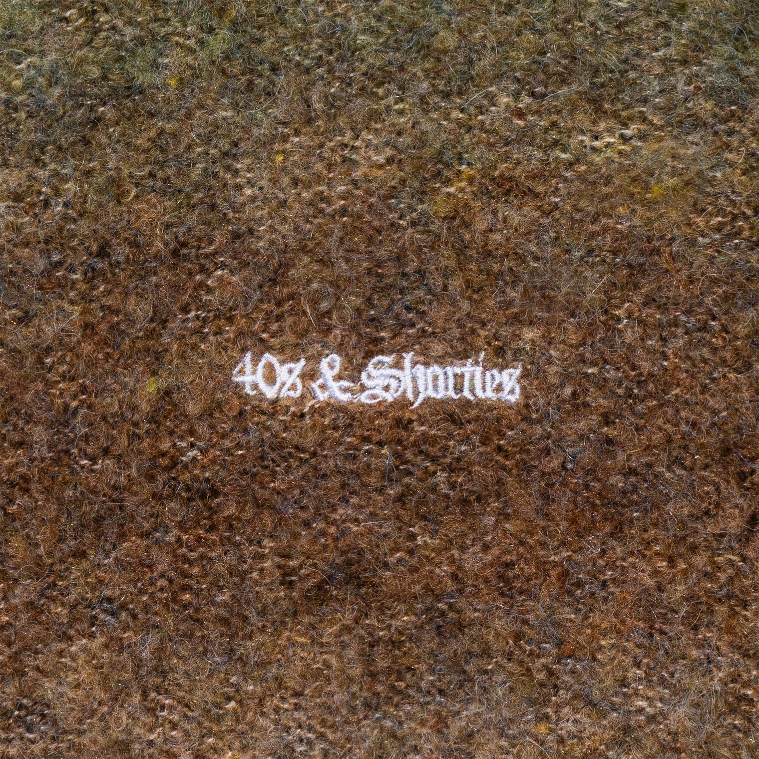 Close-up of chest embroidery detail on the Teen Spirit Sweater – Green
