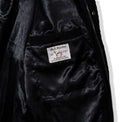 Inside view of the jacket showing satin lining and woven label