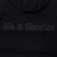 Close-up of tonal logo applique on the back of the jacket