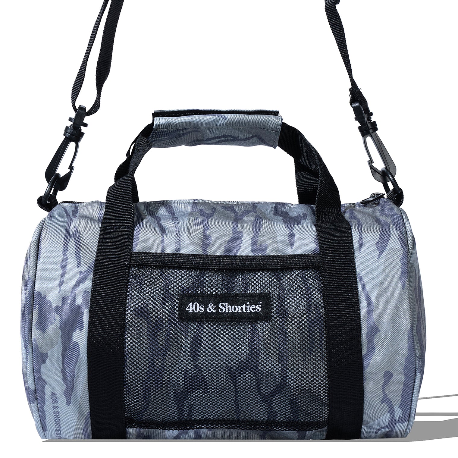 Close-up detail of alternative logo patch and front mesh pocket on mini camo duffle