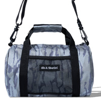 Close-up detail of alternative logo patch and front mesh pocket on mini camo duffle