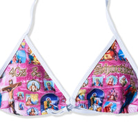 Close-up of printed bikini top featuring saints and icons on pink background
