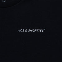 Close-up of the front chest logo reading “40s & Shorties” on black cotton.
