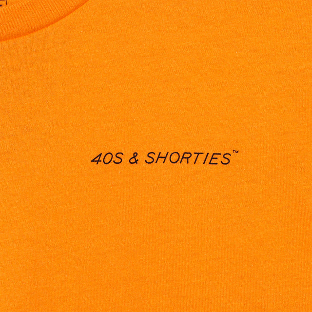 Close-up of front chest print on the Grid Tee Tangerine featuring "40s & Shorties" text in black.
