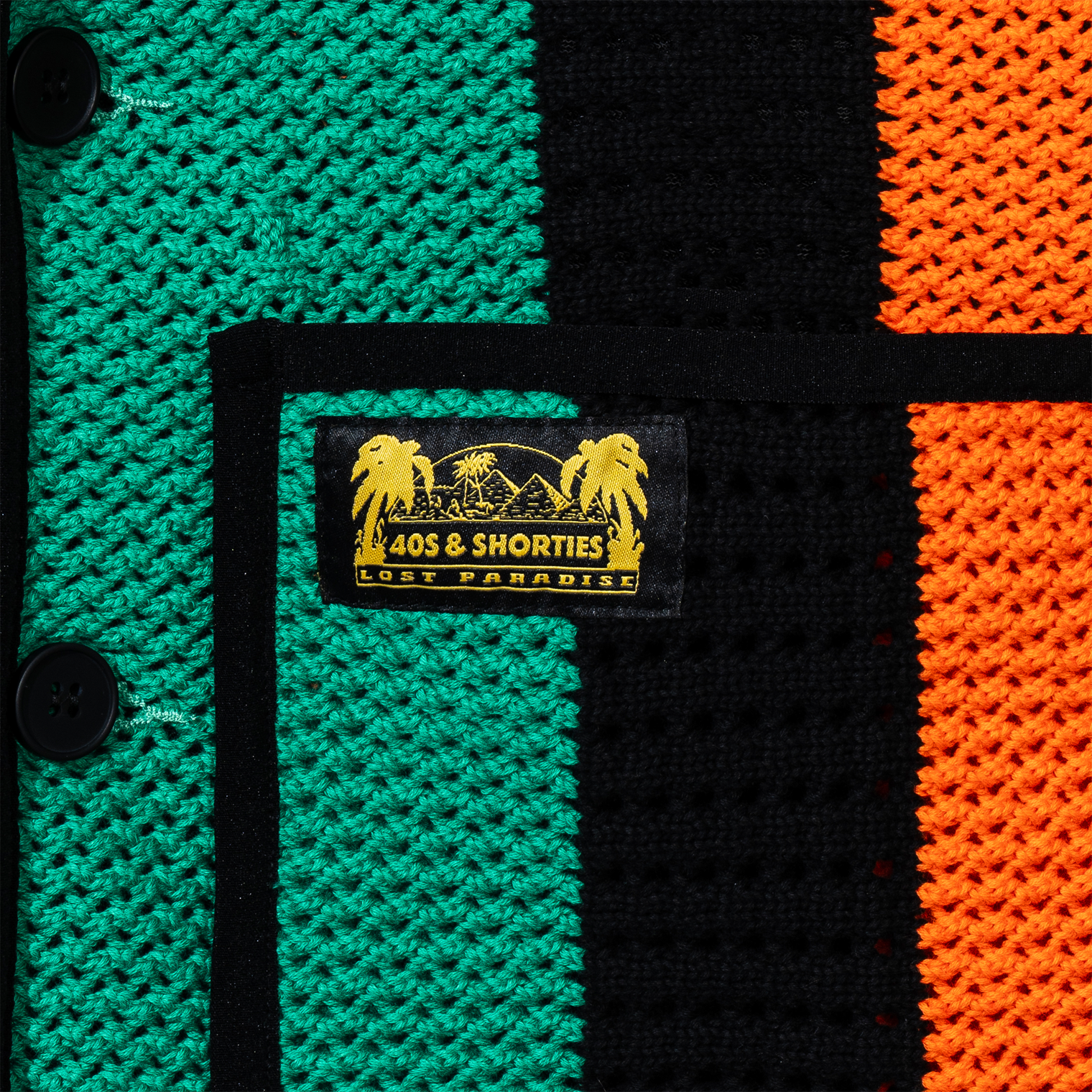 Close-up of pocket label – Yellow and black woven "40s & Shorties Lost Paradise" label stitched above the right pocket.
