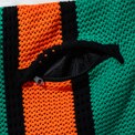 Close-up of zippered back pocket on Beachside Basketball Shorts showing black mesh lining and orange knit texture.