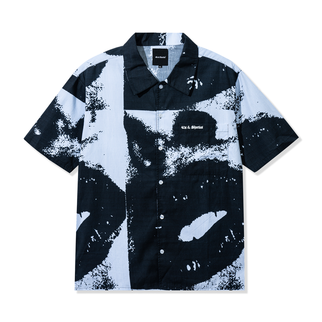 Front view of the Lips Shirt in Black featuring a bold digitally printed lips graphic on hickory striped cotton with button closure and chest pocket.
