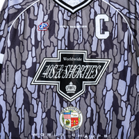 Close-up of 40s & Shorties front chest logo on Champs Hockey Jersey – Camo
