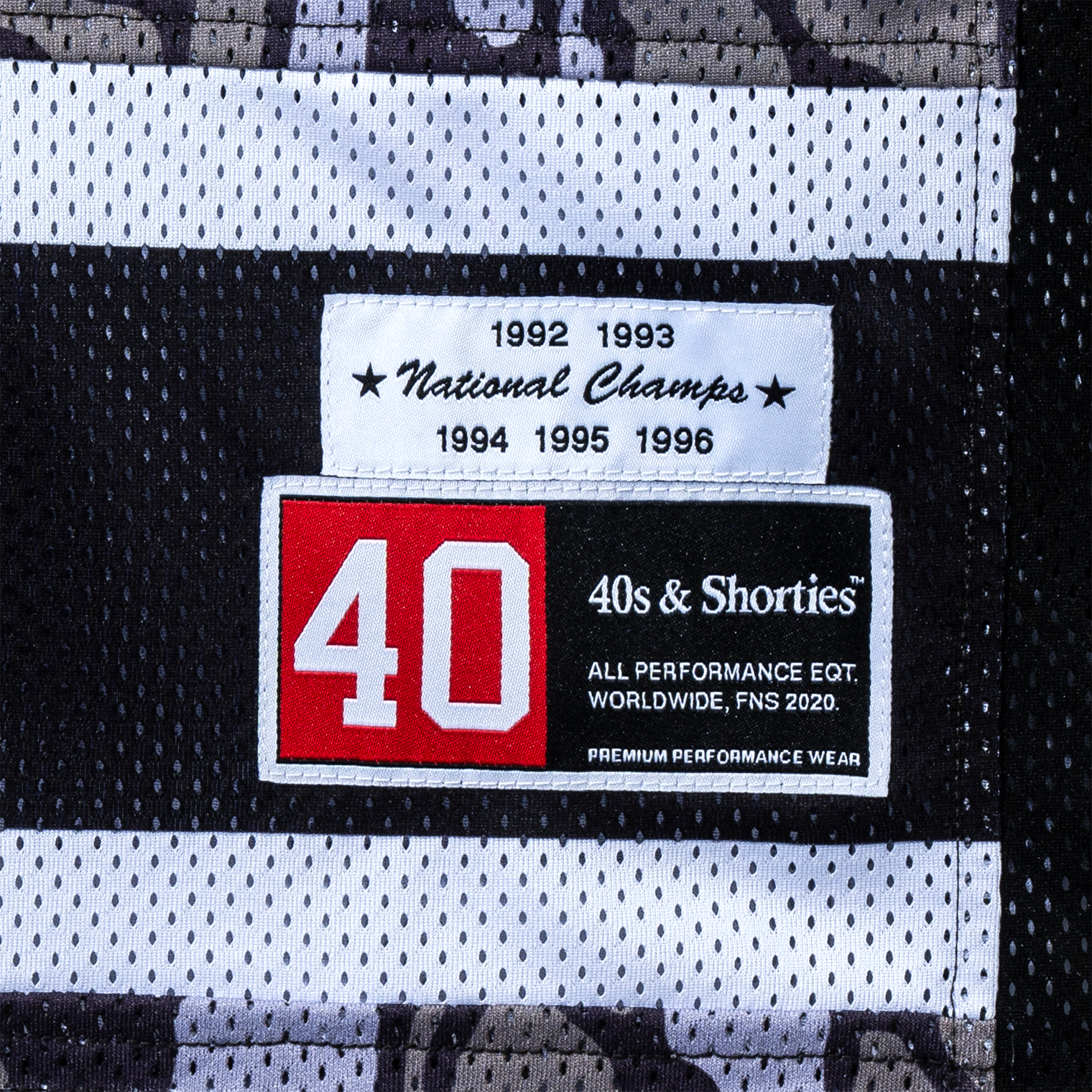 Woven patch detail on the hem of the Champs Hockey Jersey – Camo
